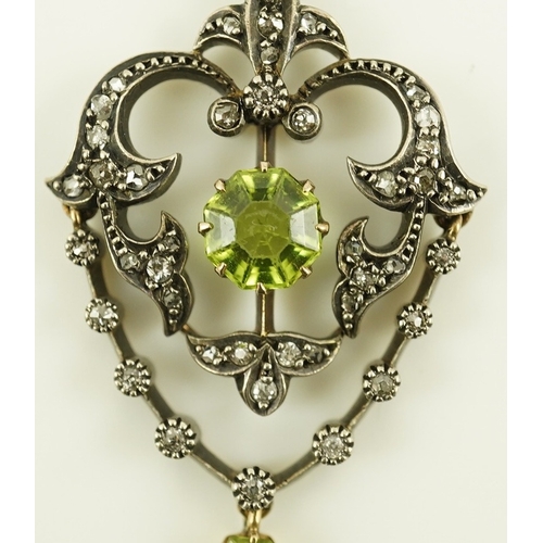 146 - A Victorian gold and silver, peridot and diamond cluster set articulated drop pendant, with octagona... 