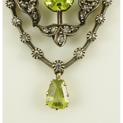 146 - A Victorian gold and silver, peridot and diamond cluster set articulated drop pendant, with octagona... 