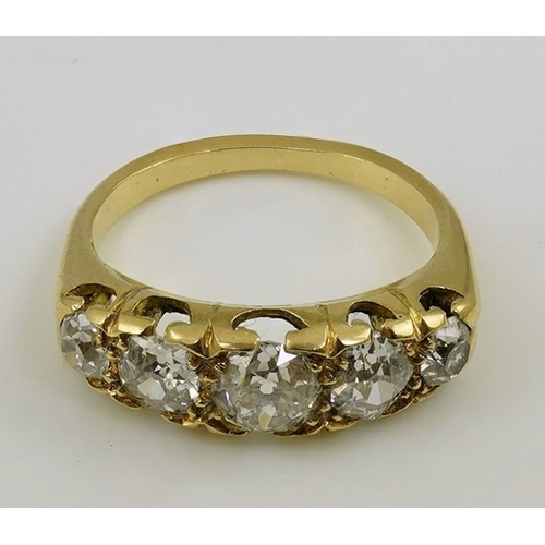 148 - An antique gold and graduated five stone old mine cut diamond set half hoop ring, total diamond weig... 