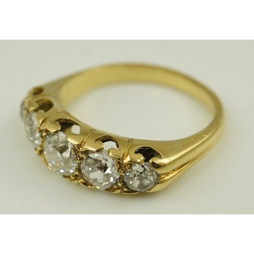 148 - An antique gold and graduated five stone old mine cut diamond set half hoop ring, total diamond weig... 