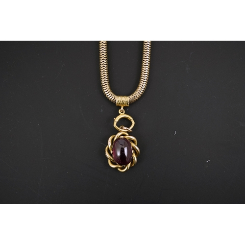 151 - A Victorian gold snake link chain, hung with a gold and single stone oval cabochon garnet set mourni... 