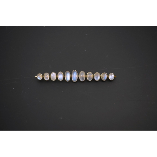 154 - A gold and eleven stone graduated cabochon moonstone set bar brooch, 89mm, gross weight 9.5 grams.... 