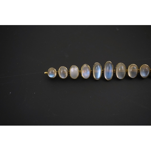 154 - A gold and eleven stone graduated cabochon moonstone set bar brooch, 89mm, gross weight 9.5 grams.... 