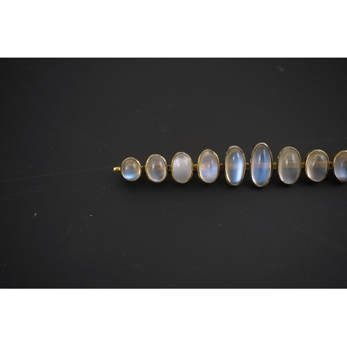 154 - A gold and eleven stone graduated cabochon moonstone set bar brooch, 89mm, gross weight 9.5 grams.... 