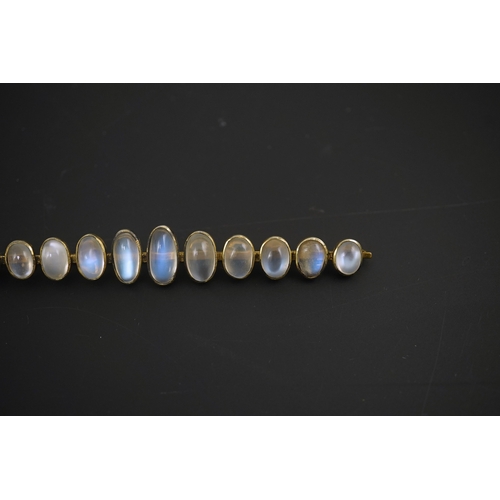 154 - A gold and eleven stone graduated cabochon moonstone set bar brooch, 89mm, gross weight 9.5 grams.... 