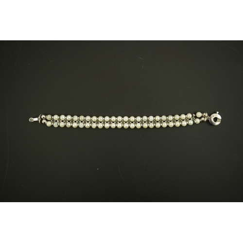 157 - A late 20th century 18k white gold and two row cultured pearl bracelet, set with single row of caboc... 