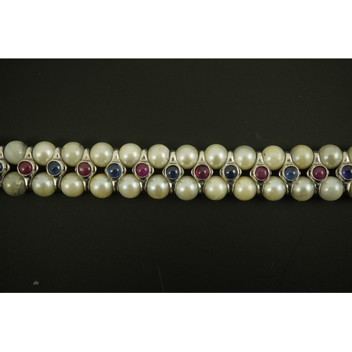 157 - A late 20th century 18k white gold and two row cultured pearl bracelet, set with single row of caboc... 