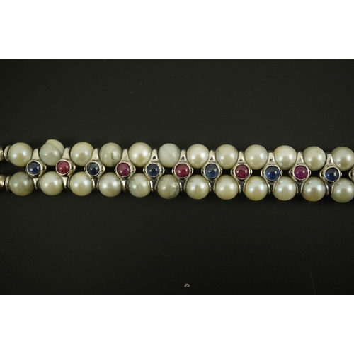 157 - A late 20th century 18k white gold and two row cultured pearl bracelet, set with single row of caboc... 