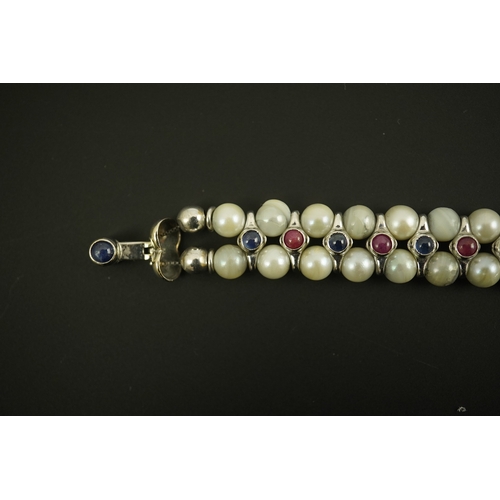 157 - A late 20th century 18k white gold and two row cultured pearl bracelet, set with single row of caboc... 