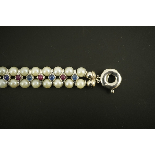 157 - A late 20th century 18k white gold and two row cultured pearl bracelet, set with single row of caboc... 