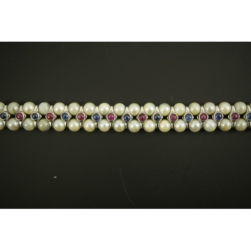 157 - A late 20th century 18k white gold and two row cultured pearl bracelet, set with single row of caboc... 