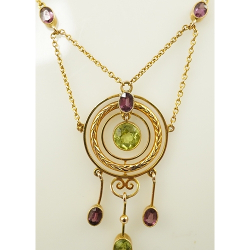 164 - An Edwardian 9ct gold, peridot and garnet set drop pendant necklace, by Murrle Bennett & Co, of targ... 