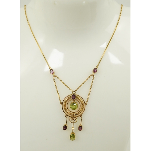 164 - An Edwardian 9ct gold, peridot and garnet set drop pendant necklace, by Murrle Bennett & Co, of targ... 