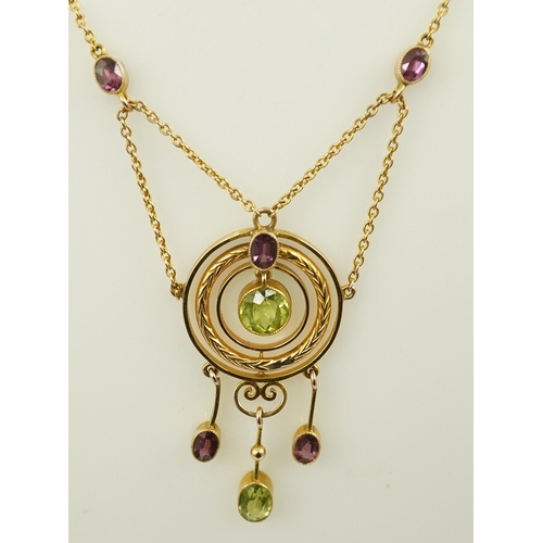 164 - An Edwardian 9ct gold, peridot and garnet set drop pendant necklace, by Murrle Bennett & Co, of targ... 