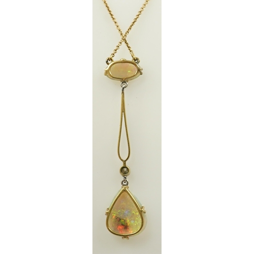 167 - An early 20th century gold, two stone white opal and single stone diamond set drop pendant necklace,... 