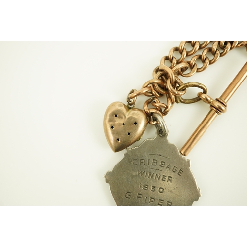 171 - An early 20th century 9ct gold graduated curb link albert, hung with a silver medallion and a heart ... 