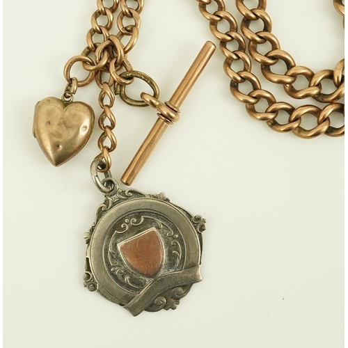 171 - An early 20th century 9ct gold graduated curb link albert, hung with a silver medallion and a heart ... 