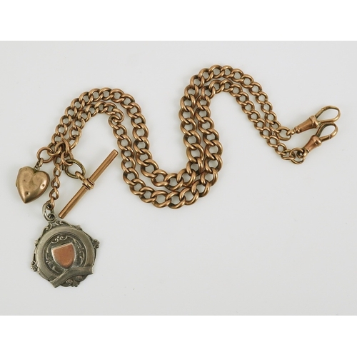 171 - An early 20th century 9ct gold graduated curb link albert, hung with a silver medallion and a heart ... 