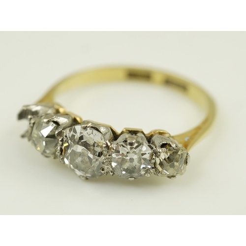 172 - An early 20th century 18ct gold, platinum and graduated five stone old mine cut diamond set half hoo... 