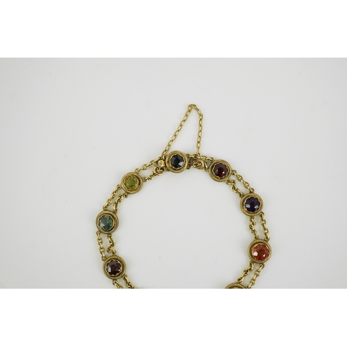 174 - An early 20th century yellow metal and ten stone multi gem set chain link bracelet, 16cm, gross weig... 