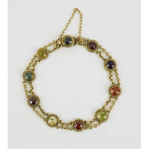 174 - An early 20th century yellow metal and ten stone multi gem set chain link bracelet, 16cm, gross weig... 