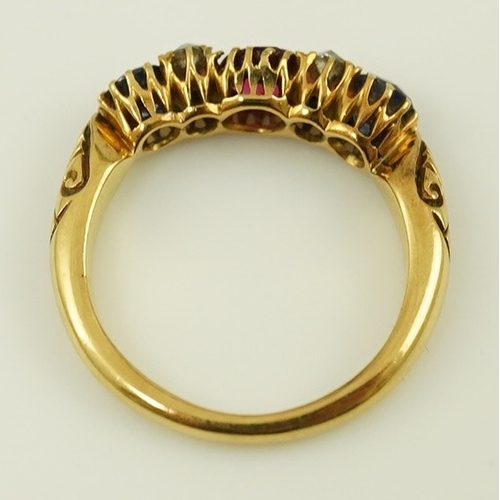 175 - An early 20th century gold, ruby, sapphire and diamond cluster set half hoop ring, size J, gross wei... 