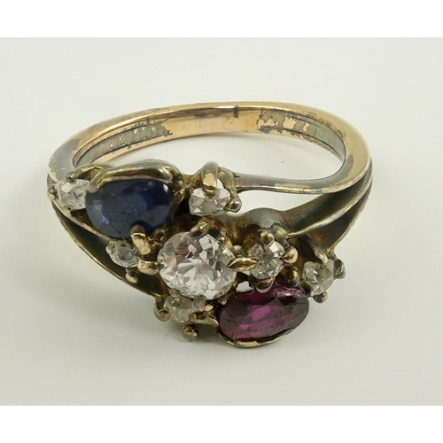 180 - An early 20th century style gold, ruby, sapphire and diamond cluster set triple shank ring, size P/Q... 