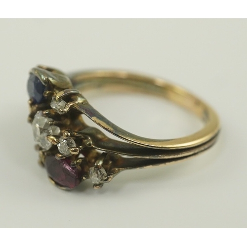 180 - An early 20th century style gold, ruby, sapphire and diamond cluster set triple shank ring, size P/Q... 