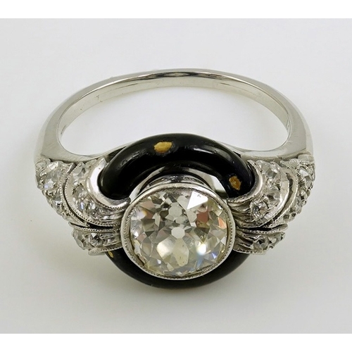 185 - An Art Deco platinum black enamel and diamond set ring, with diamond set shoulders, the central ston... 