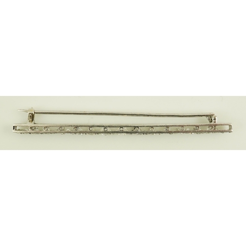 187 - A 1920's platinum? and nineteen millegrain set graduated diamond bar brooch, 59mm, gross weight 4.6 ... 