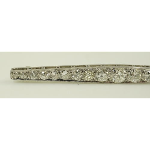 187 - A 1920's platinum? and nineteen millegrain set graduated diamond bar brooch, 59mm, gross weight 4.6 ... 