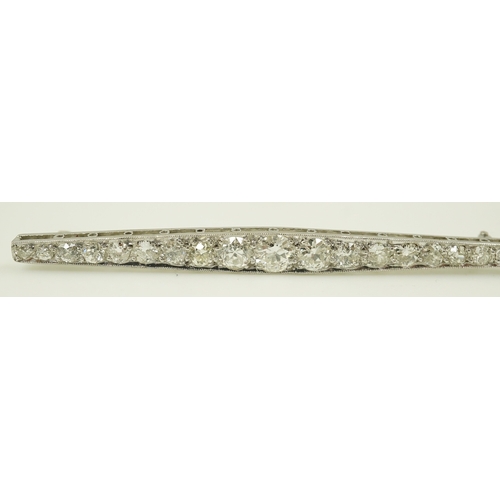 187 - A 1920's platinum? and nineteen millegrain set graduated diamond bar brooch, 59mm, gross weight 4.6 ... 