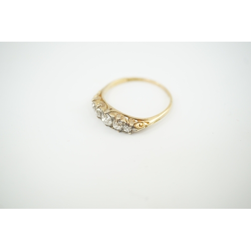 191 - An early 20th century gold and graduated five stone old cut diamond set half hoop ring, with diamond... 