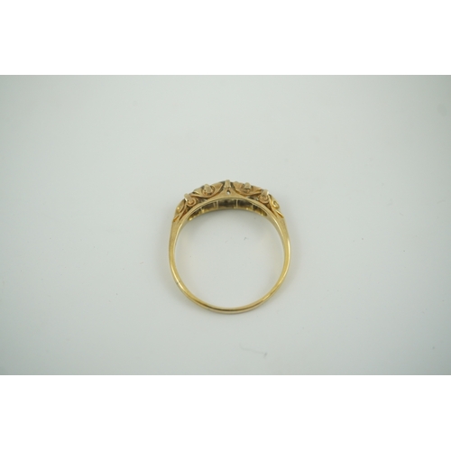 191 - An early 20th century gold and graduated five stone old cut diamond set half hoop ring, with diamond... 