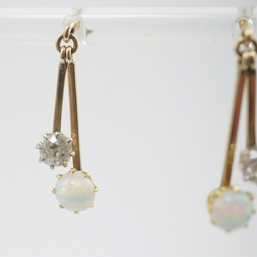 193 - A pair of 9ct gold, white opal and diamond set double drop earrings, 23mm, gross weight 2.2 grams.... 