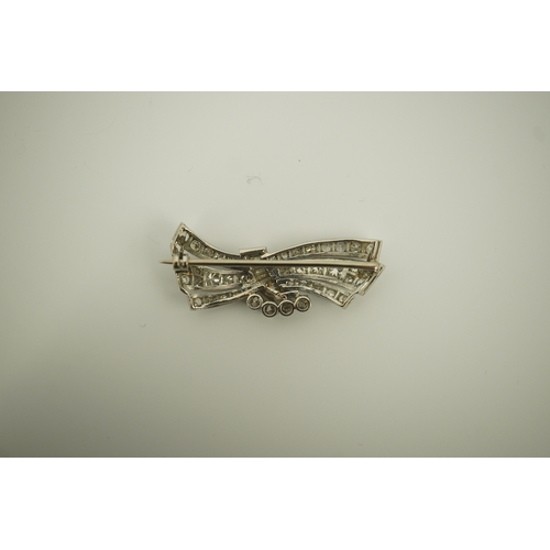 196 - A mid 20th century platinum? and diamond cluster scroll brooch, set with baguette and round cut diam... 