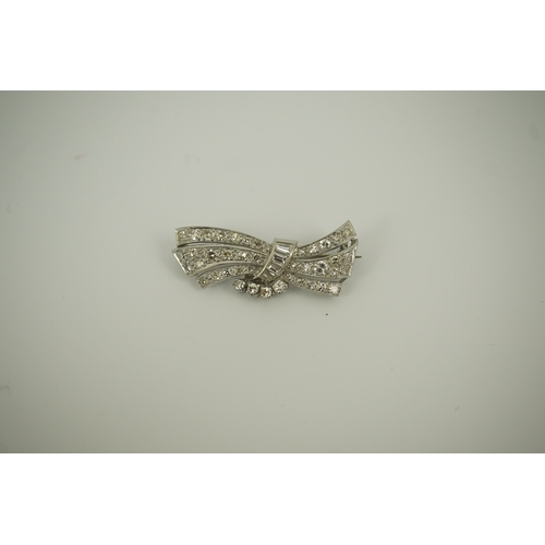 196 - A mid 20th century platinum? and diamond cluster scroll brooch, set with baguette and round cut diam... 