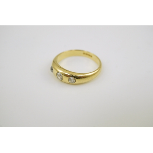 197 - A George V 18ct gold and three stone gypsy set diamond ring, size S, gross weight 6.8 grams.