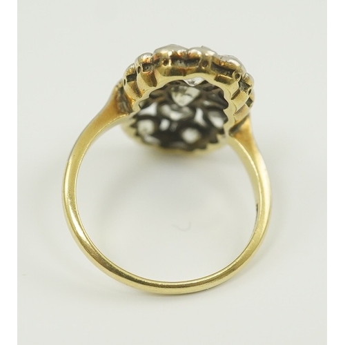 198 - A 1940's 18ct gold, platinum and millegrain set diamond oval cluster ring, size O, gross weight 5 gr... 