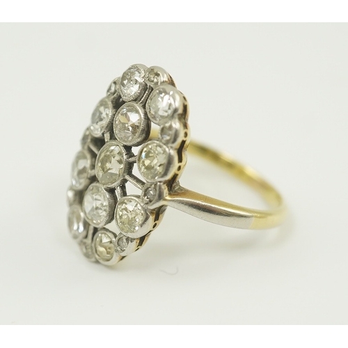 198 - A 1940's 18ct gold, platinum and millegrain set diamond oval cluster ring, size O, gross weight 5 gr... 