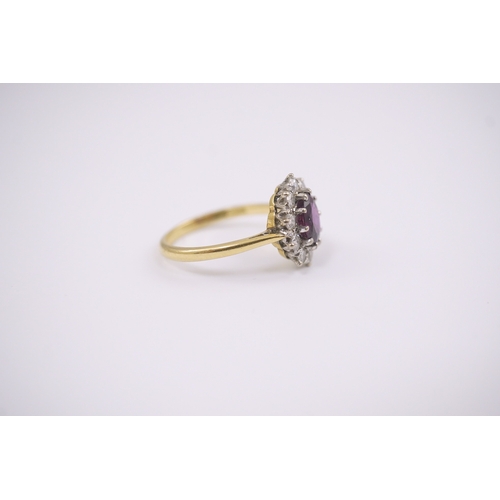 203 - An 18ct gold and platinum, ruby and diamond set oval cluster ring, size N, gross weight 3.6 grams.... 