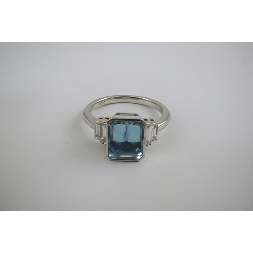 205 - An Art Deco style platinum and single stone emerald cut aquamarine set dress ring, with four stone g... 