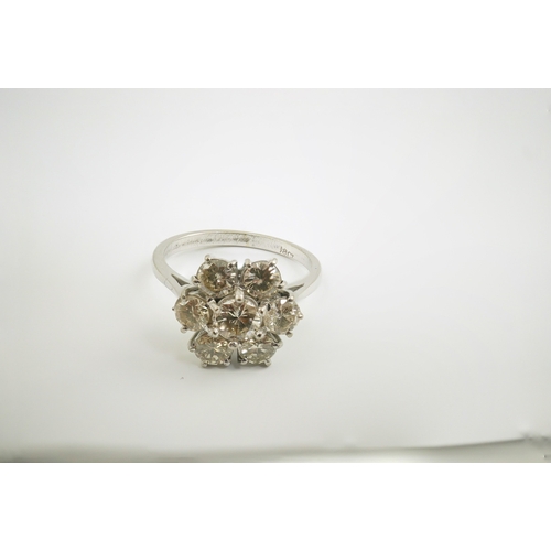 207 - An 18ct white gold and seven stone diamond set flower head cluster ring, size M, gross weight 4 gram... 