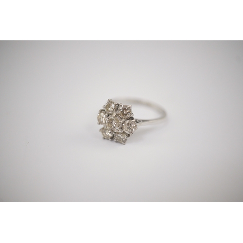 207 - An 18ct white gold and seven stone diamond set flower head cluster ring, size M, gross weight 4 gram... 