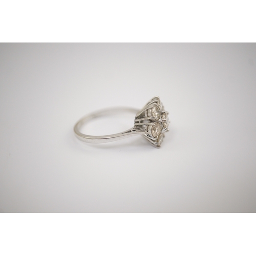 207 - An 18ct white gold and seven stone diamond set flower head cluster ring, size M, gross weight 4 gram... 