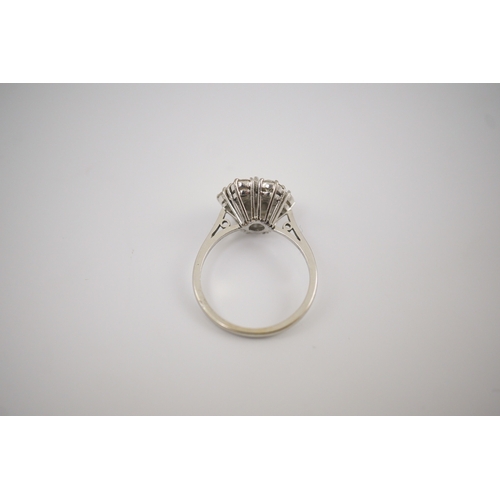 207 - An 18ct white gold and seven stone diamond set flower head cluster ring, size M, gross weight 4 gram... 