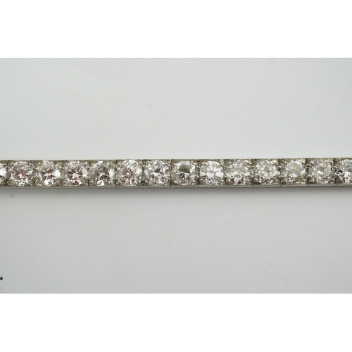 214 - A mid to late 20th century and diamond line bracelet, set with thirty three round brilliant cut ston... 