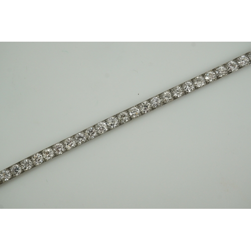 214 - A mid to late 20th century and diamond line bracelet, set with thirty three round brilliant cut ston... 