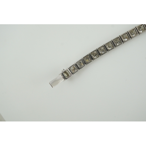 214 - A mid to late 20th century and diamond line bracelet, set with thirty three round brilliant cut ston... 