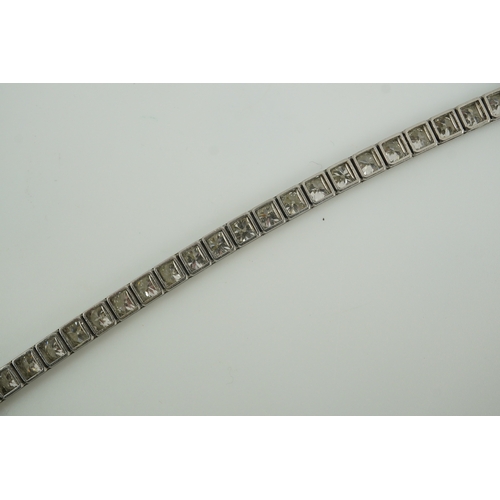 214 - A mid to late 20th century and diamond line bracelet, set with thirty three round brilliant cut ston... 